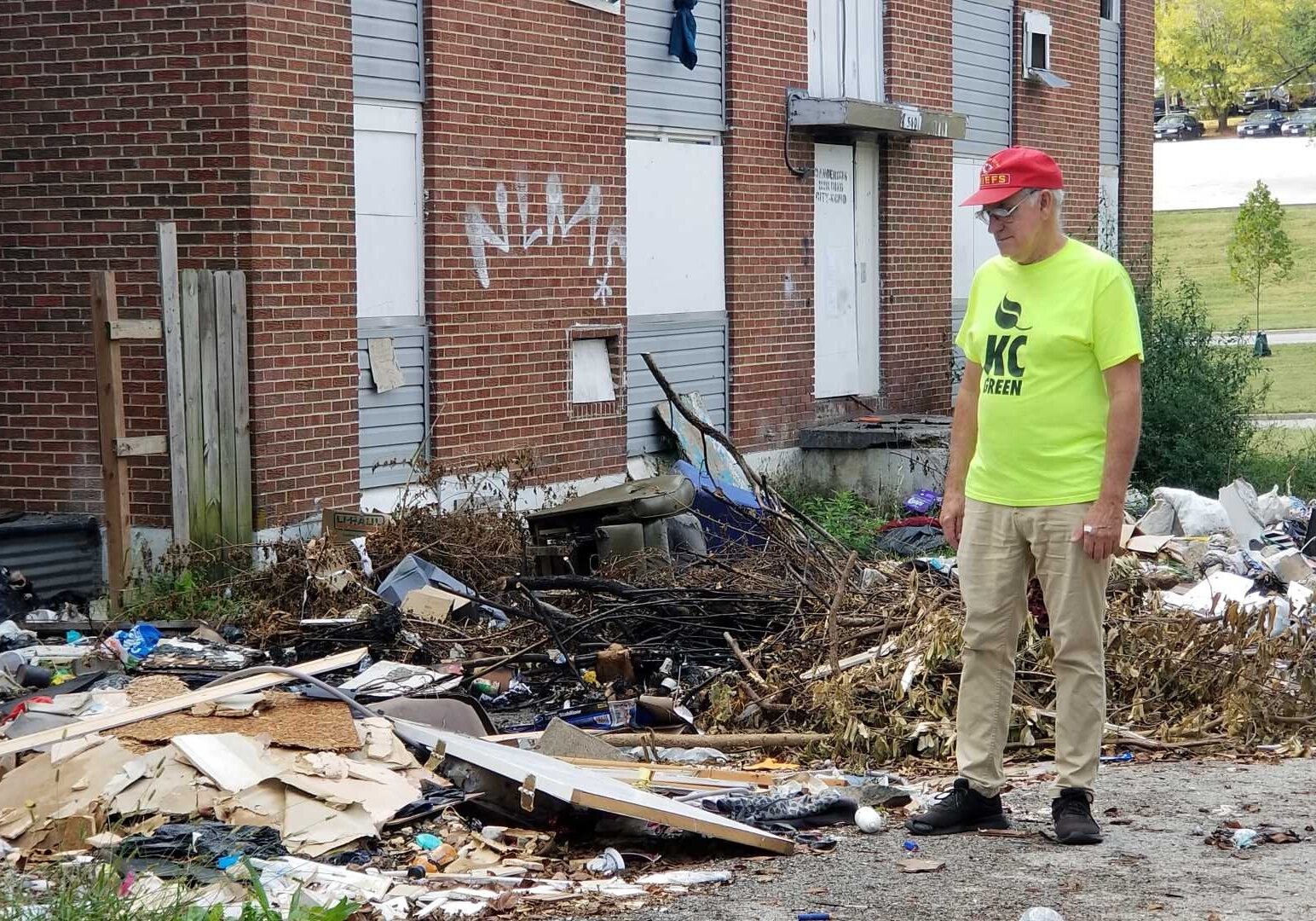 Dale Walker, president of the Blue Valley Neighborhood Association in Kansas City, surveys a trashed site near the intersection of 27th Terrace and Hardesty Avenue.