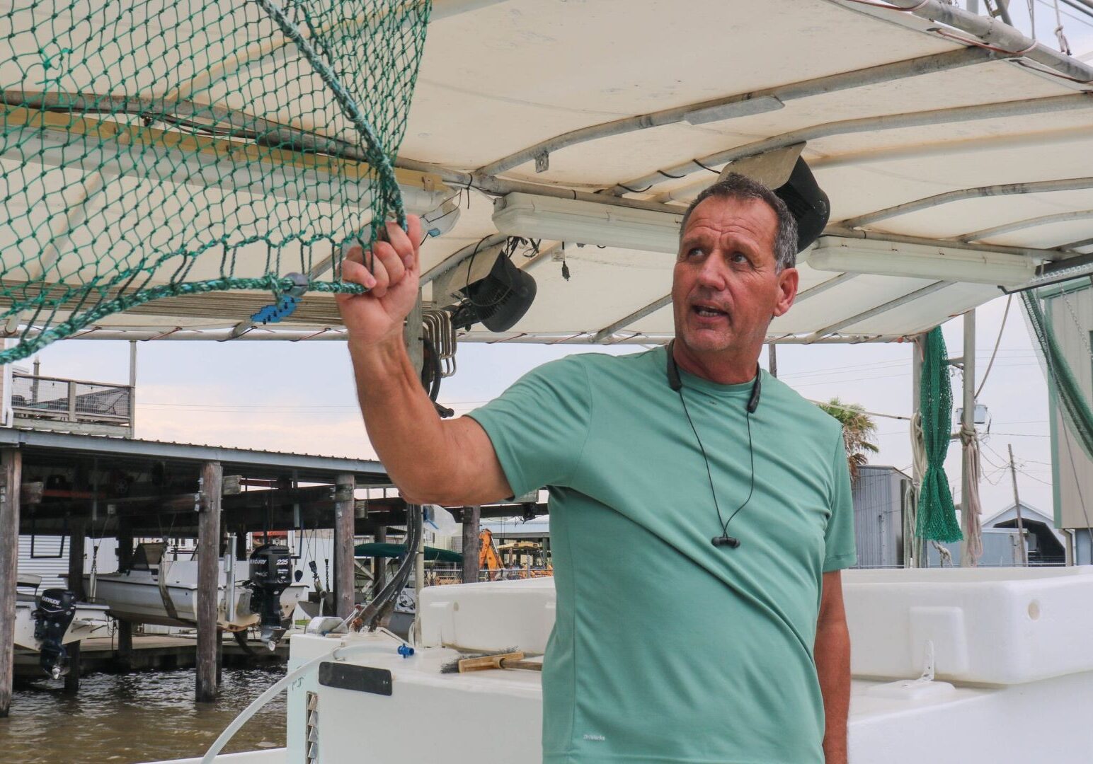 Thomas Olander, on his boat in Cypremort Point, Louisiana, shows off the nets his family uses to catch shrimp in Vermilion Bay.