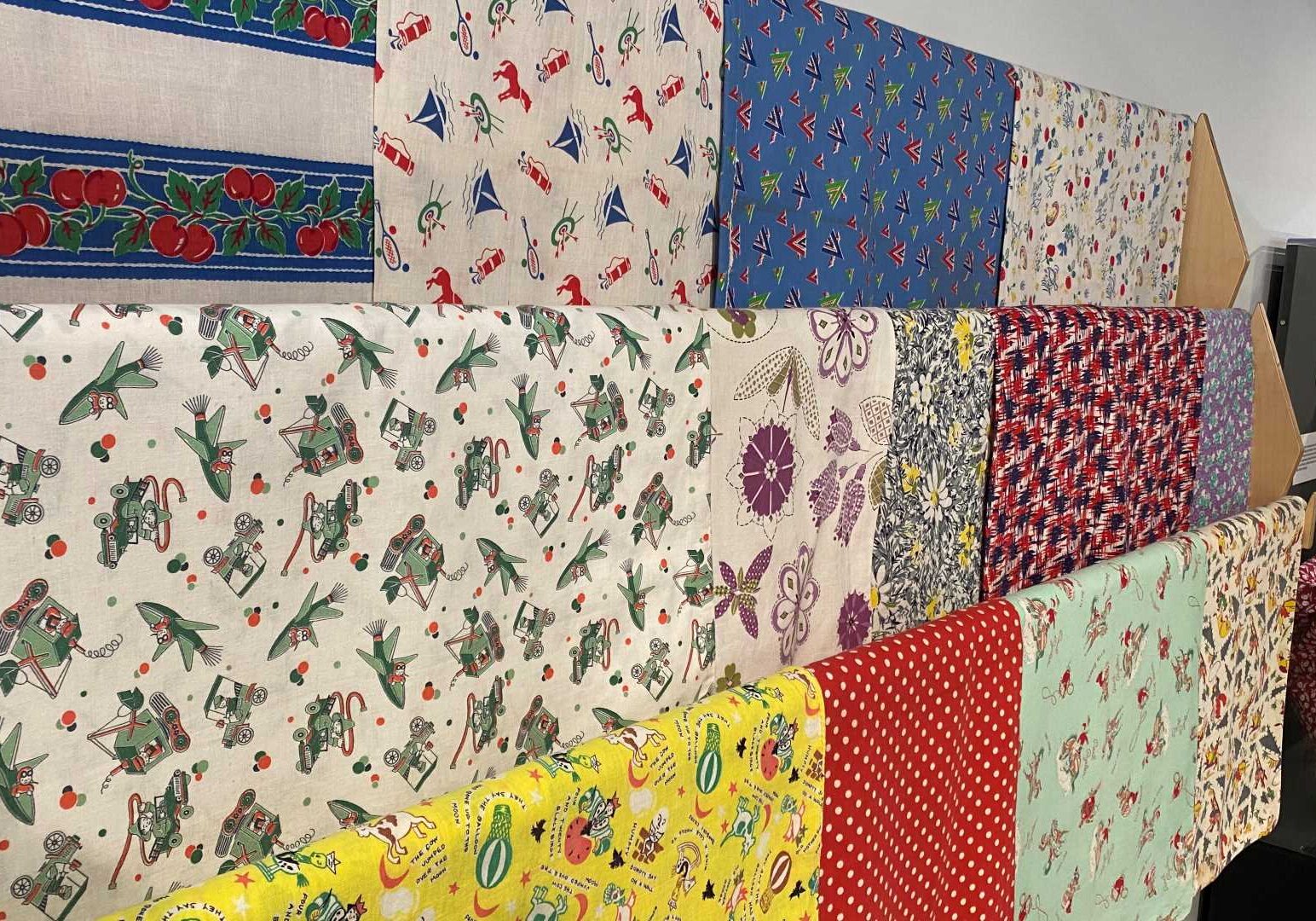 A display of feed sack patterns at the Thrift Style exhibit now showing the Johnson County Museum.