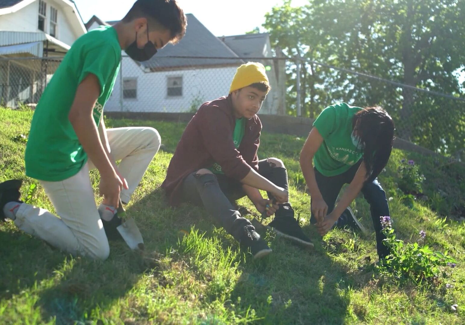 Three people planting trees in Kansas City, Kansas.