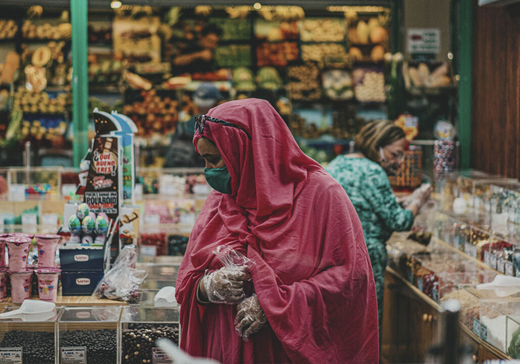 A woman shops in a farmer's market surround