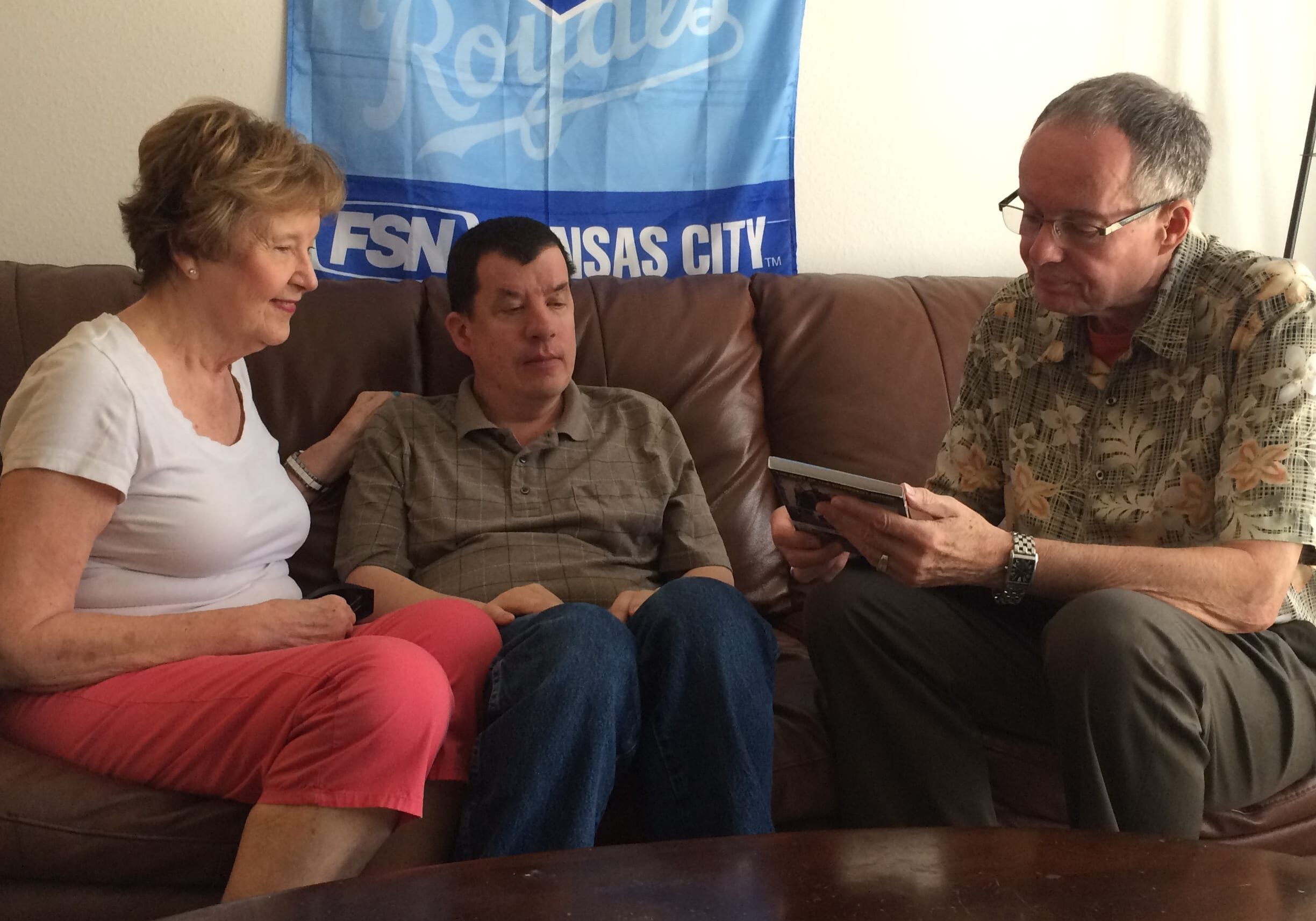 Nick Fugate (center) and his parents, Julie and Ron, have been adjusting to life on Kansas’ Medicaid waiting list for the developmentally disabled. (Photo: Alex Smith | Heartland Health Monitor)