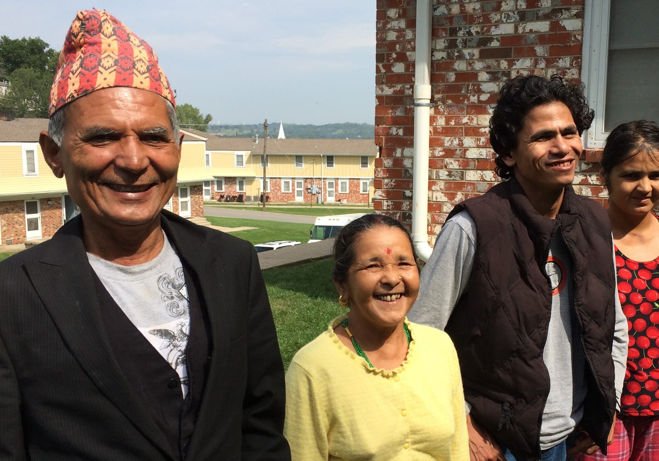 Palak and Durga Khadka with their son-in-law, Birkha, and daughter, Ganga (left to right) next to their home in Chalet Manor in Kansas City, Kan.  (Photo by Alex Smith/Heartland Health Monitor)
