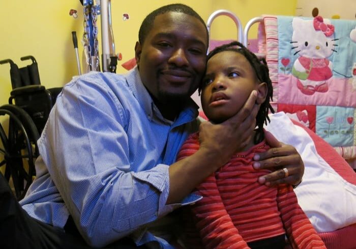 Earl McWilliams hugs his daughter Millie, who has a rare genetic disorder. A researcher at Children's Mercy Hospital in Kansas City has found that families spend from $3,000 to $55,000, or more, on tests. Photo: Alex Smith / Heartland Health Monitor