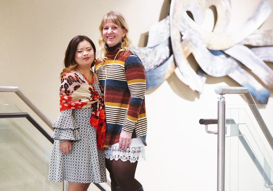 Grace Walline poses at CrossFirst Bank in Leawood with Dana Steinwart, her former special education teacher. (Brad Austin | Flatland)