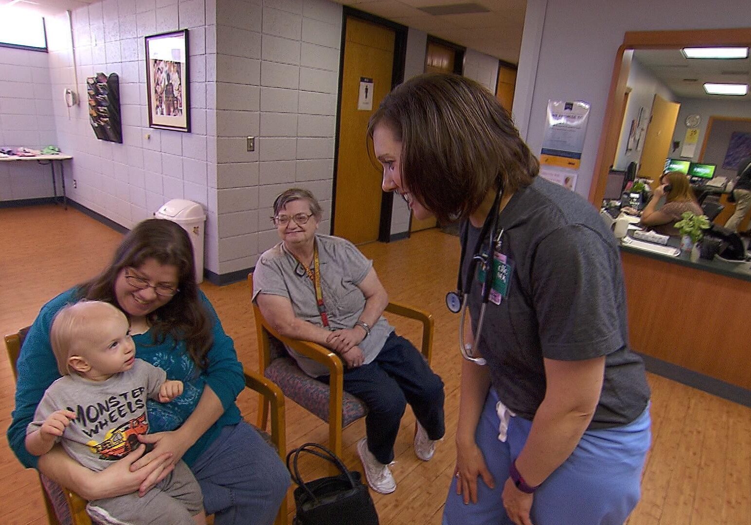 Dr. Julie Griffin greets patient Susan Walter and her family in the waiting room of the Community Health Center of Southeast Kansas in Coffeyville. Photo by Jim McLean at the Heartland Health Monitor.