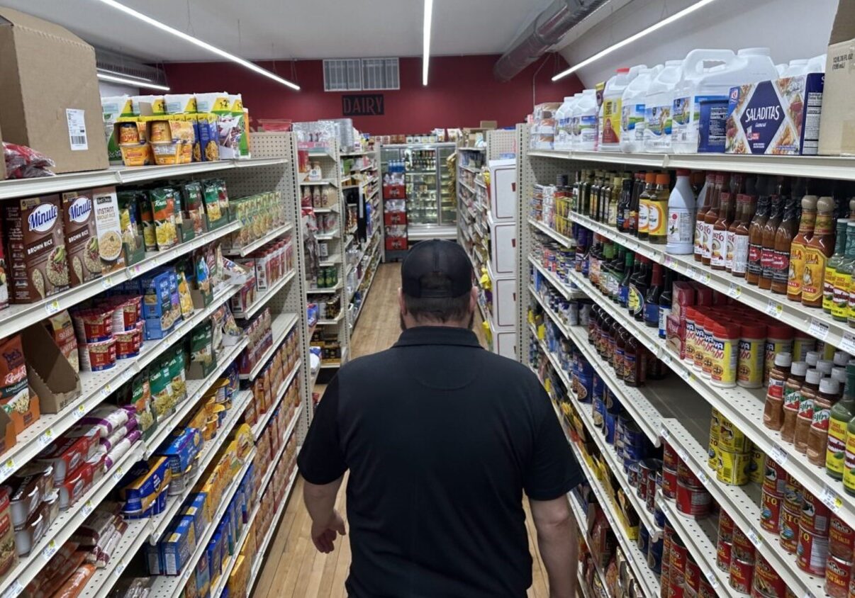 General Manager Brian Horak walks down an aisle at Post 60 Market in Emerson, Neb.
