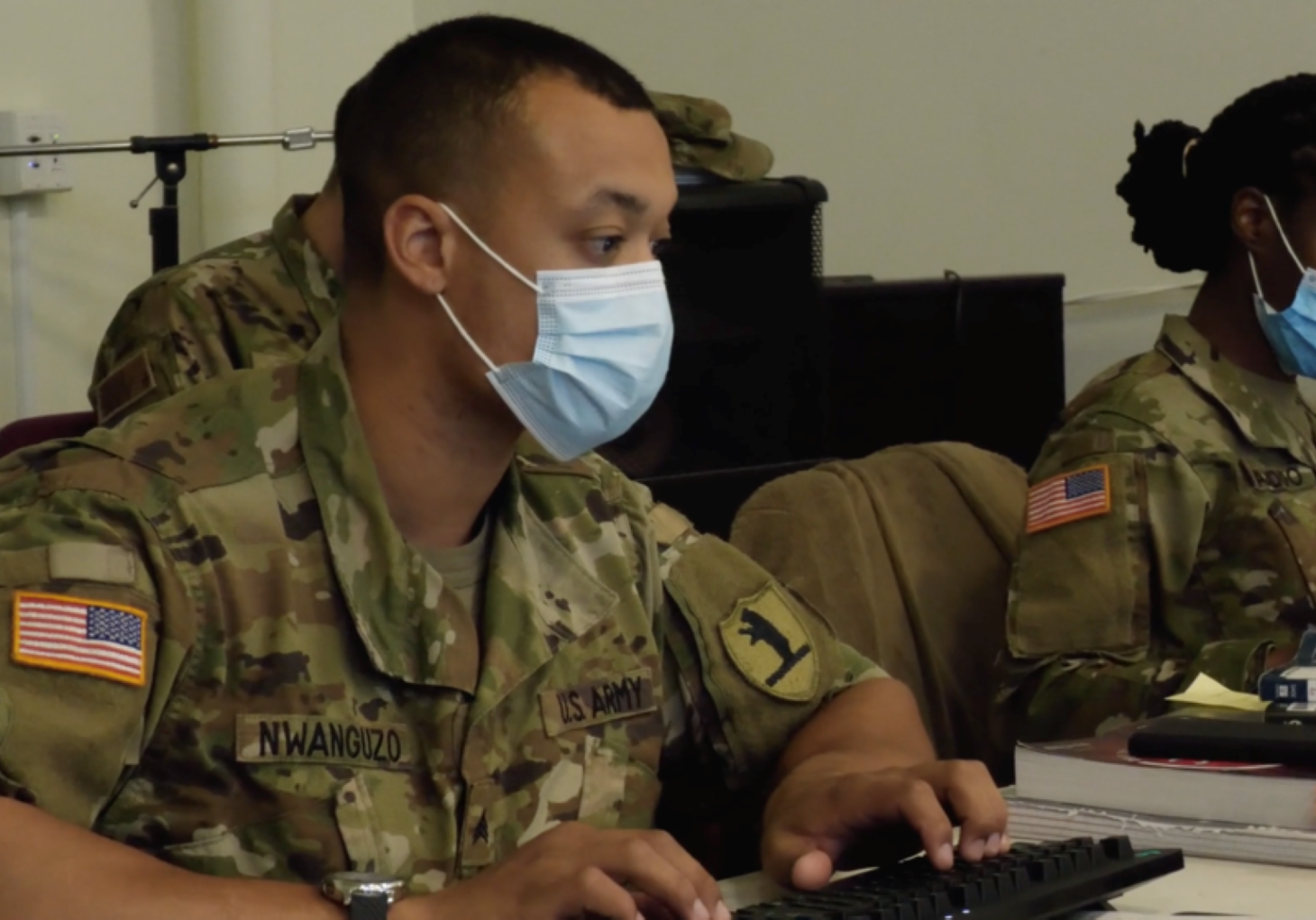 Sgt. Patrick Nwanguzo and Specialist Crystal Baddoo of the Missouri Army National Guard process Covid-19 vaccination information at the Morning Star/LINC vaccination clinic in Kansas City.