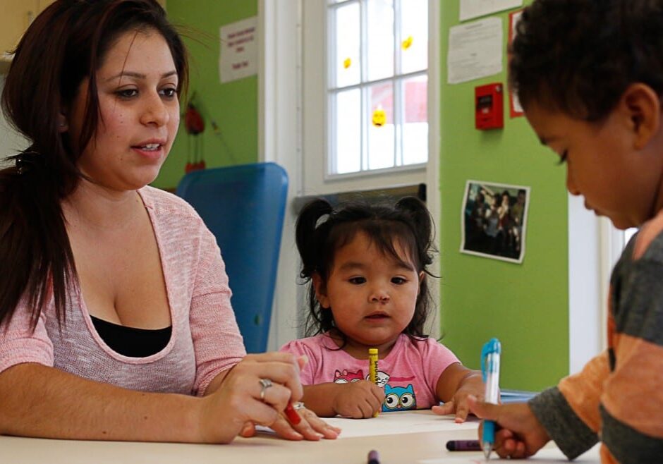 Brenda Jones, assistant teacher, works with Camila Meza-Luna, 2, and Jason Spencer, 2, in a classroom at TOP Early Learning Center in Wichita, part of the Child Start program. Child Start officials decided not to reapply for nearly $1 million in Early Head Start funding because of difficulties dealing with a state agency. (Photo by Kevin Brown)