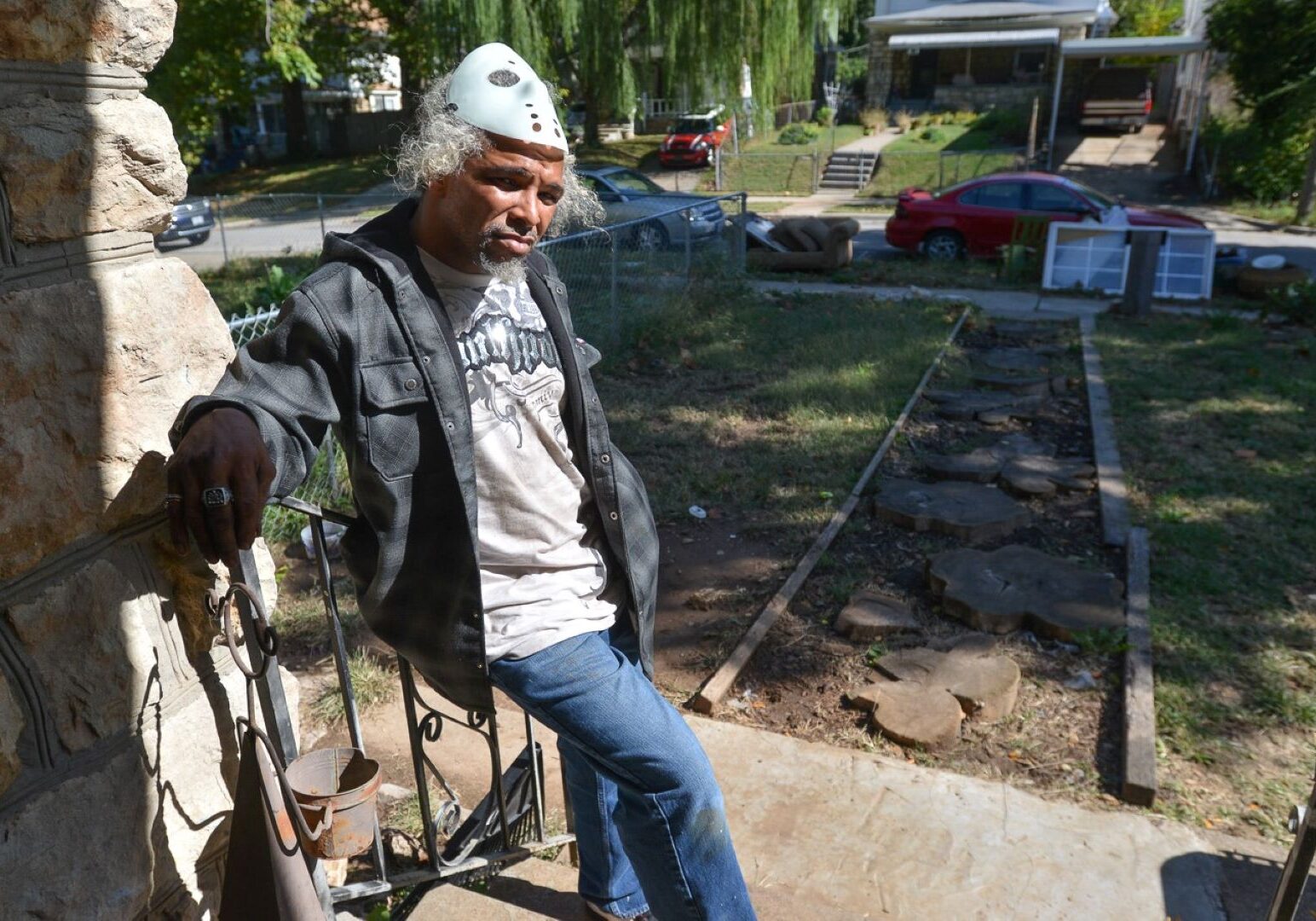 Kenneth Jenkins stands on his front porch along Montgall Avenue where he's been battling neighbors and city code enforcers.