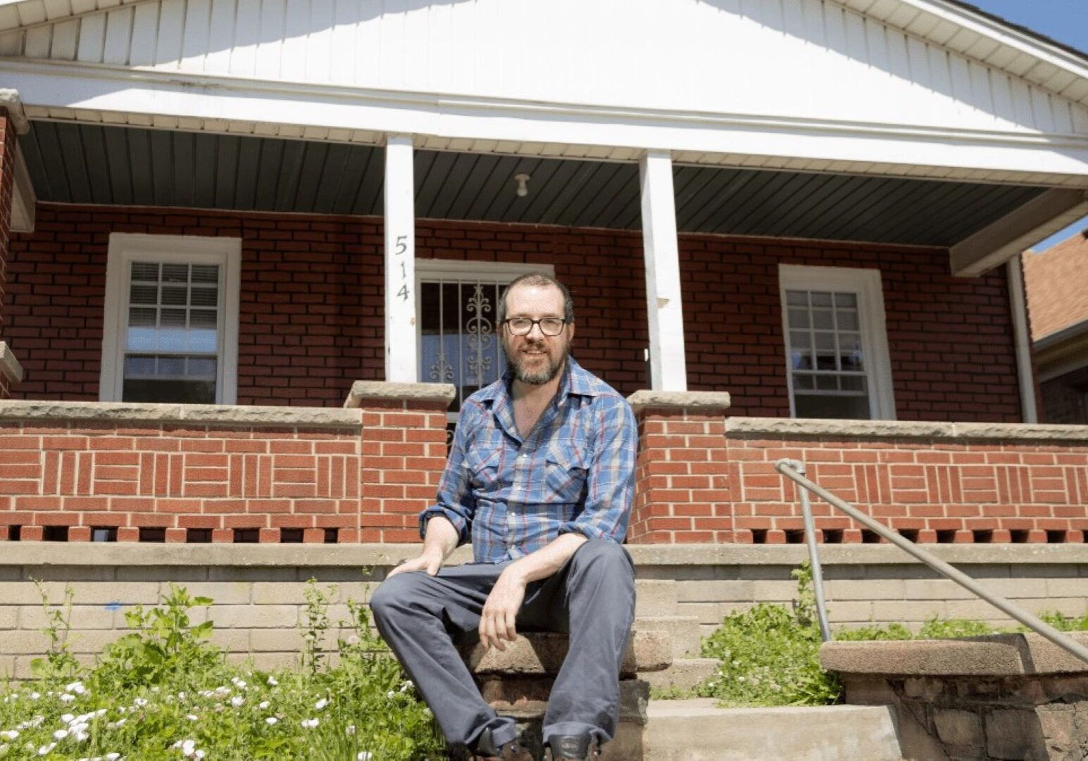 Travis Stull in front of his home in the Strawberry Hill neighborhood of Kansas City, Kansas. Stull bought his home in April.