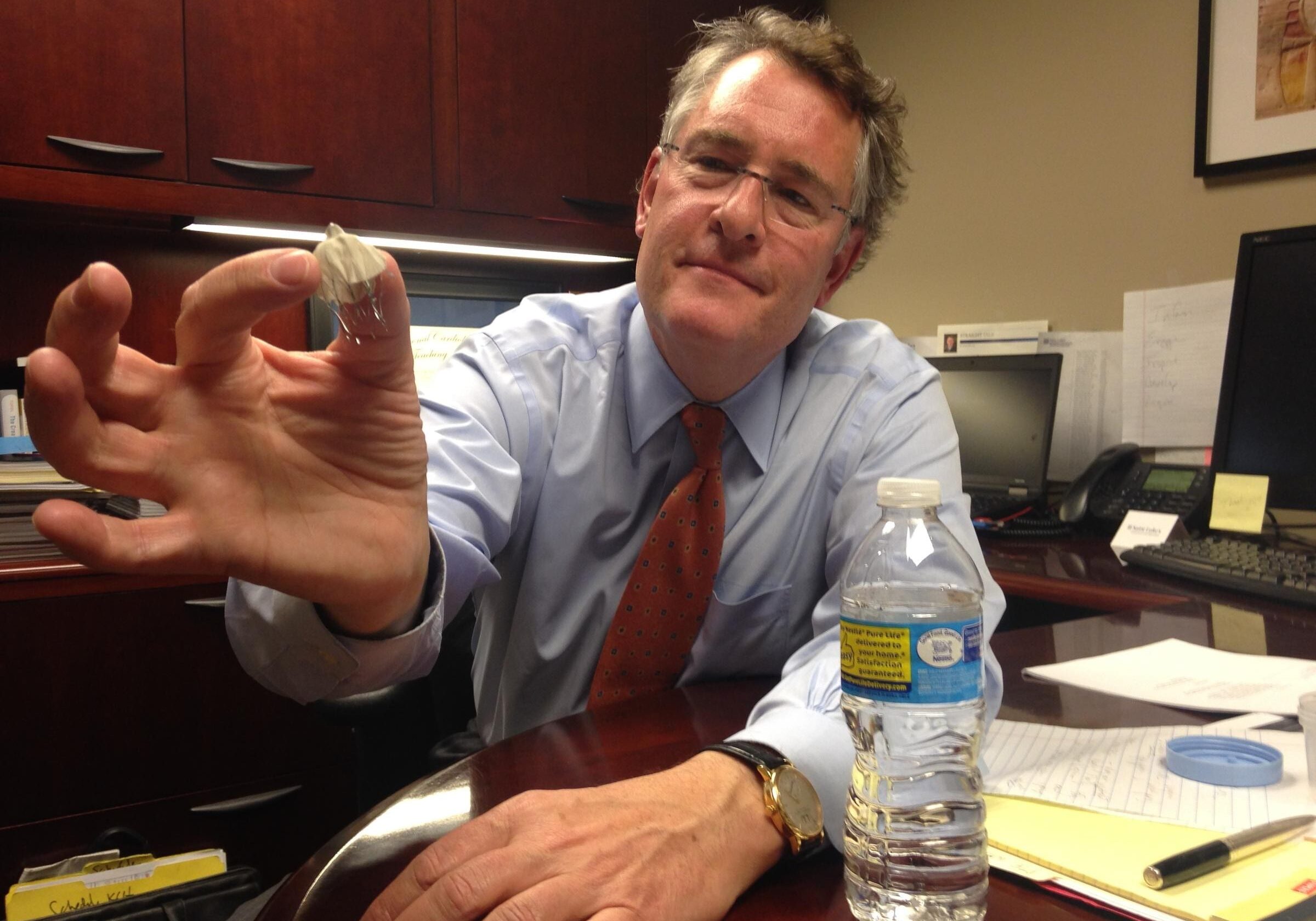 Dr. Ken Huber displays the Watchman, a device that is designed to lessen the chance of stroke in patients with atrial fibrillation.

Photo by: DAN MARGOLIES HEARTLAND HEALTH MONITOR