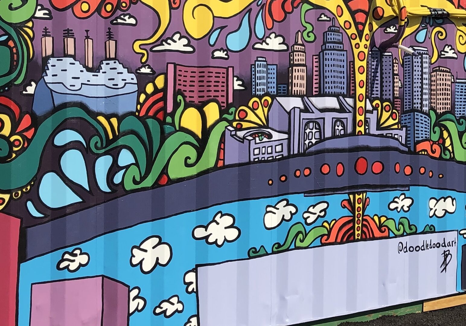 A mural of Kansas City painted on the side of a shipping container.