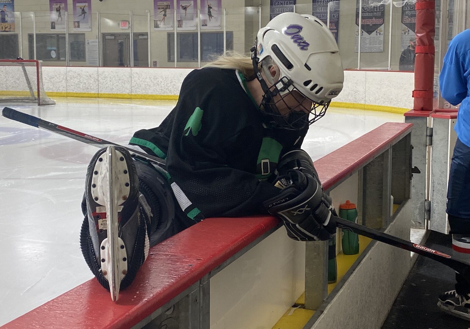 A KCWHL member stretches before taking the ice.