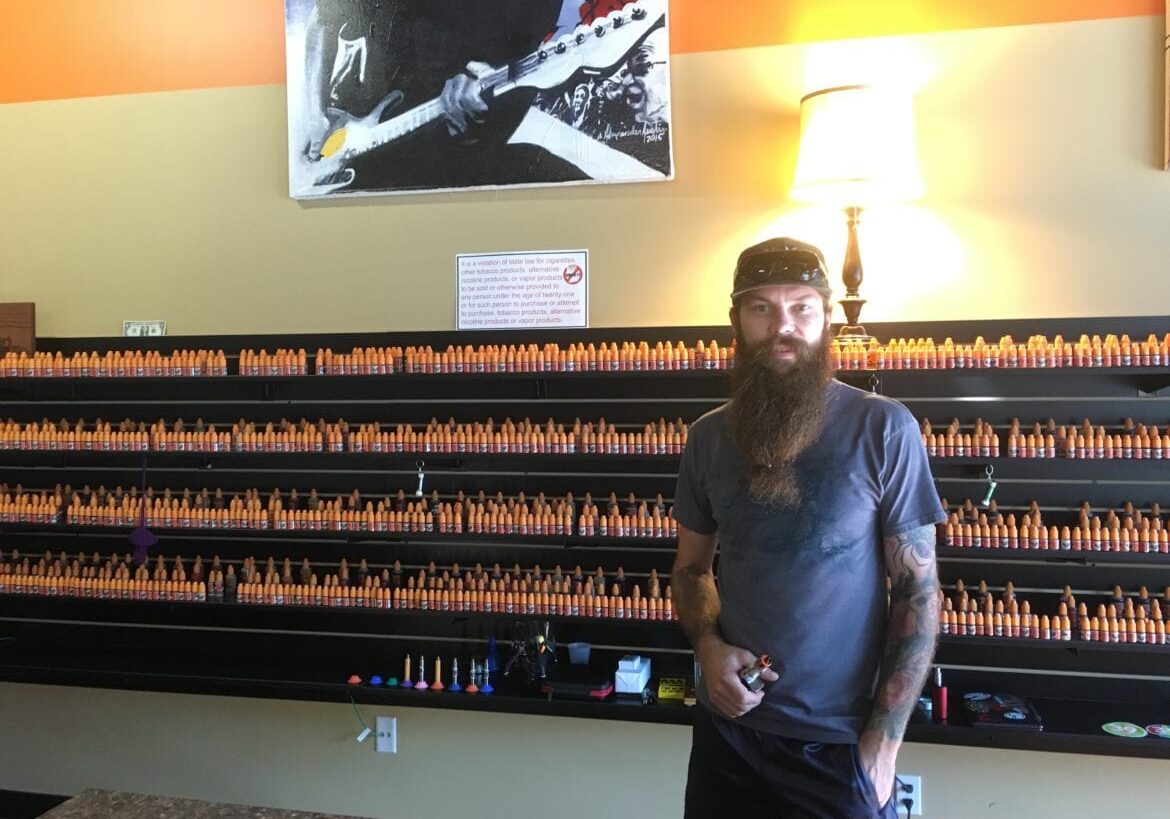 A man in front of store display
