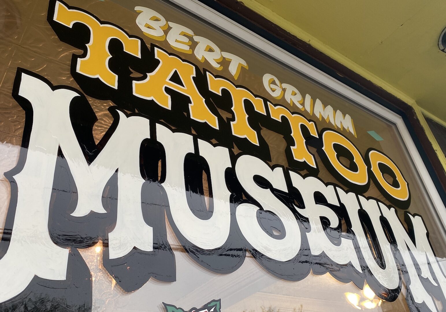 Window paint reading 'Bert Grimm Tattoo Museum'
