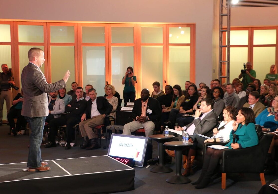 In a very "Shark Tank" like format, entrepreneur Chris Costello answers questions about his company Blooom from judges Marcelo Claure, Nicole Glaros and Miriam Rivera (center right)  at the 1 Million Cups finals Wednesday. Blooom would go on to win the event. (Photo: Daniel Boothe | Flatland) 