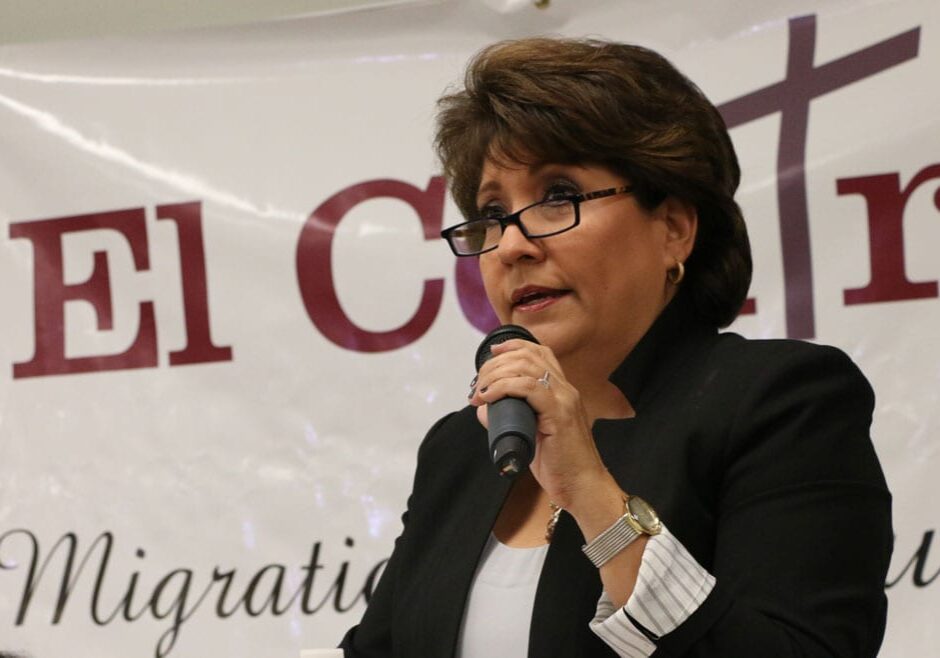 Latina woman speaks at a podium