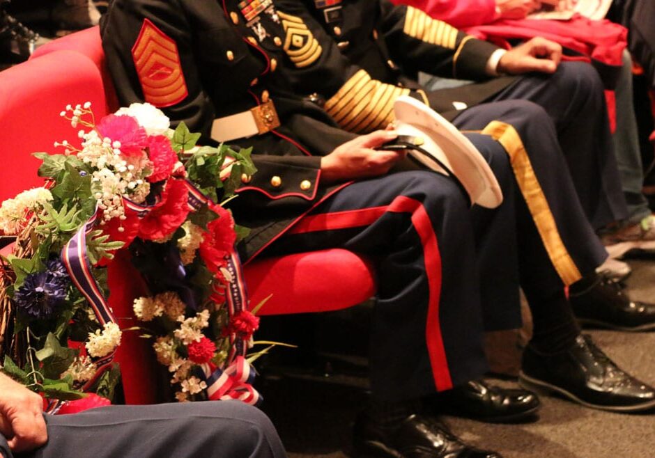 A patriotic wreath waits to be placed on an empty chair meant to honor the POWs and MIAs that could not be part of this Veterans Day celebration. (photo by Caitlin Cress/Hale Center for Journalism)