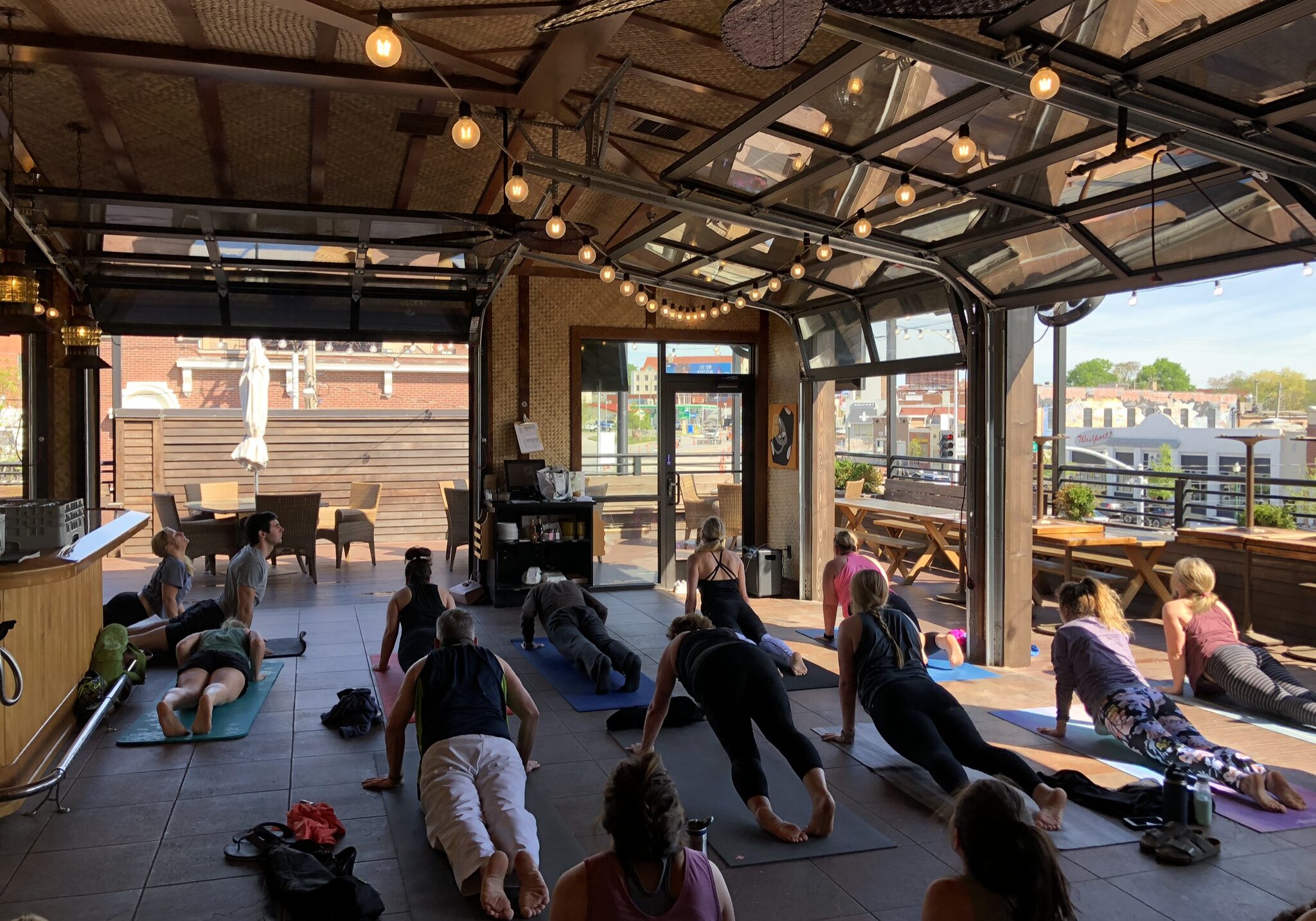A yoga class goes through a rooftop sequence.