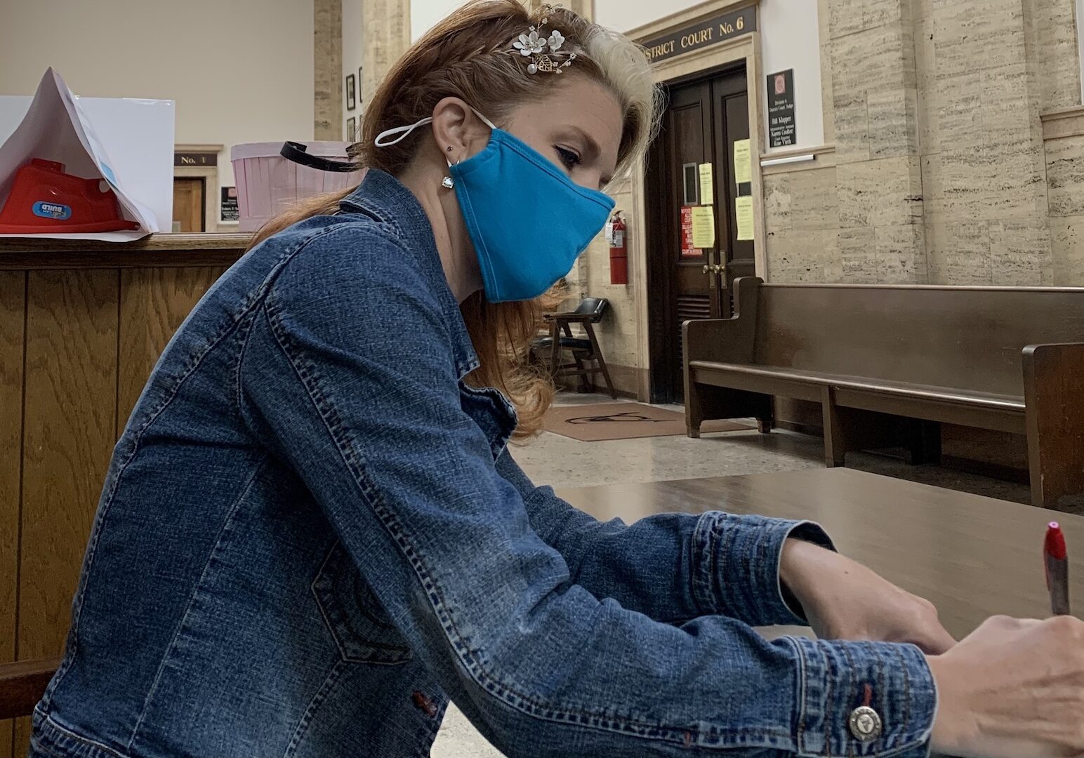 Stacy Welkom signing marriage documents.