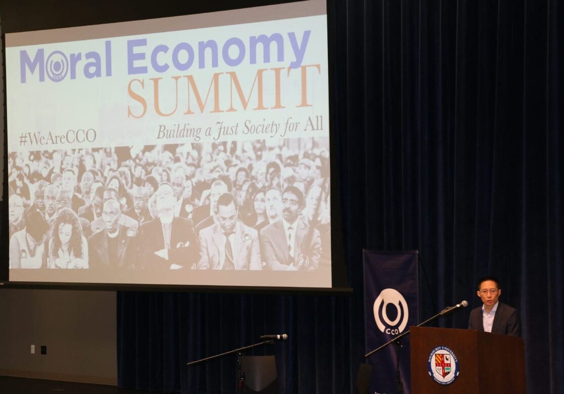 A man speaking in front of a power point presentation
