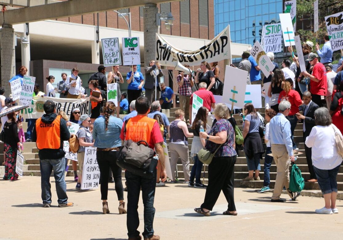 Protestors gathered at Barney Allis Plaza on 12th Street in Kansas City outside of a federal hearing to protest against the small-loan industry. (Photo: Daniel Boothe | Flatland) 