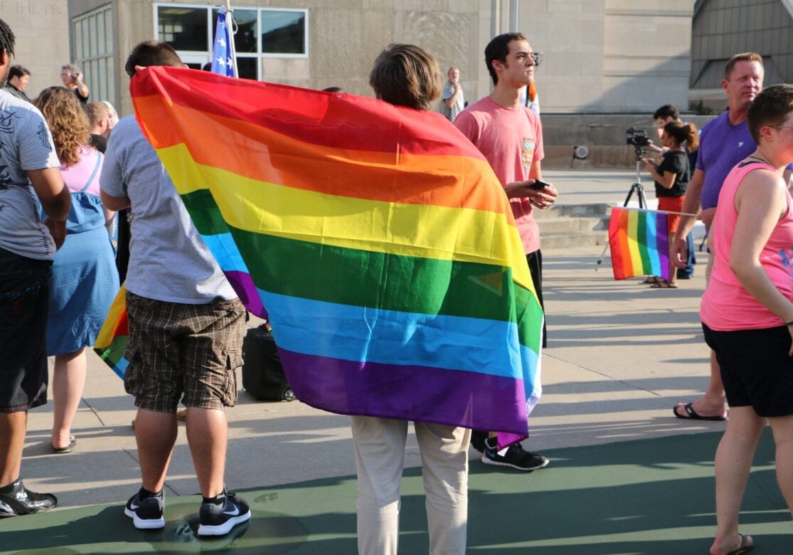 A person with a rainbow Pride flag.