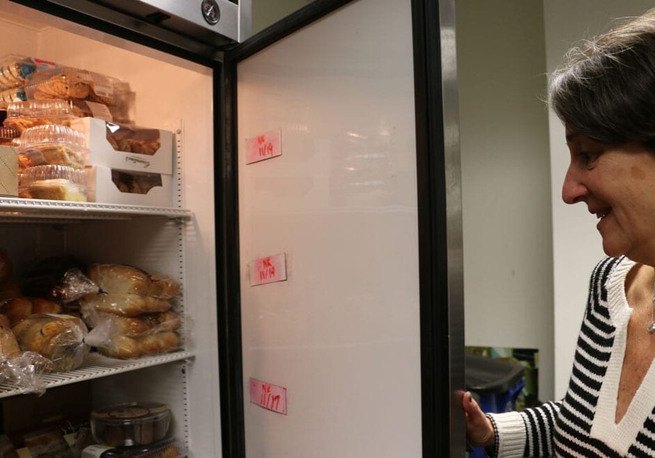 Rachel Krantz opens the refrigerator that holds much of the JFS food pantry's perishable food. (Photo by Bridgit Bowden/Hale Center for Journalism)