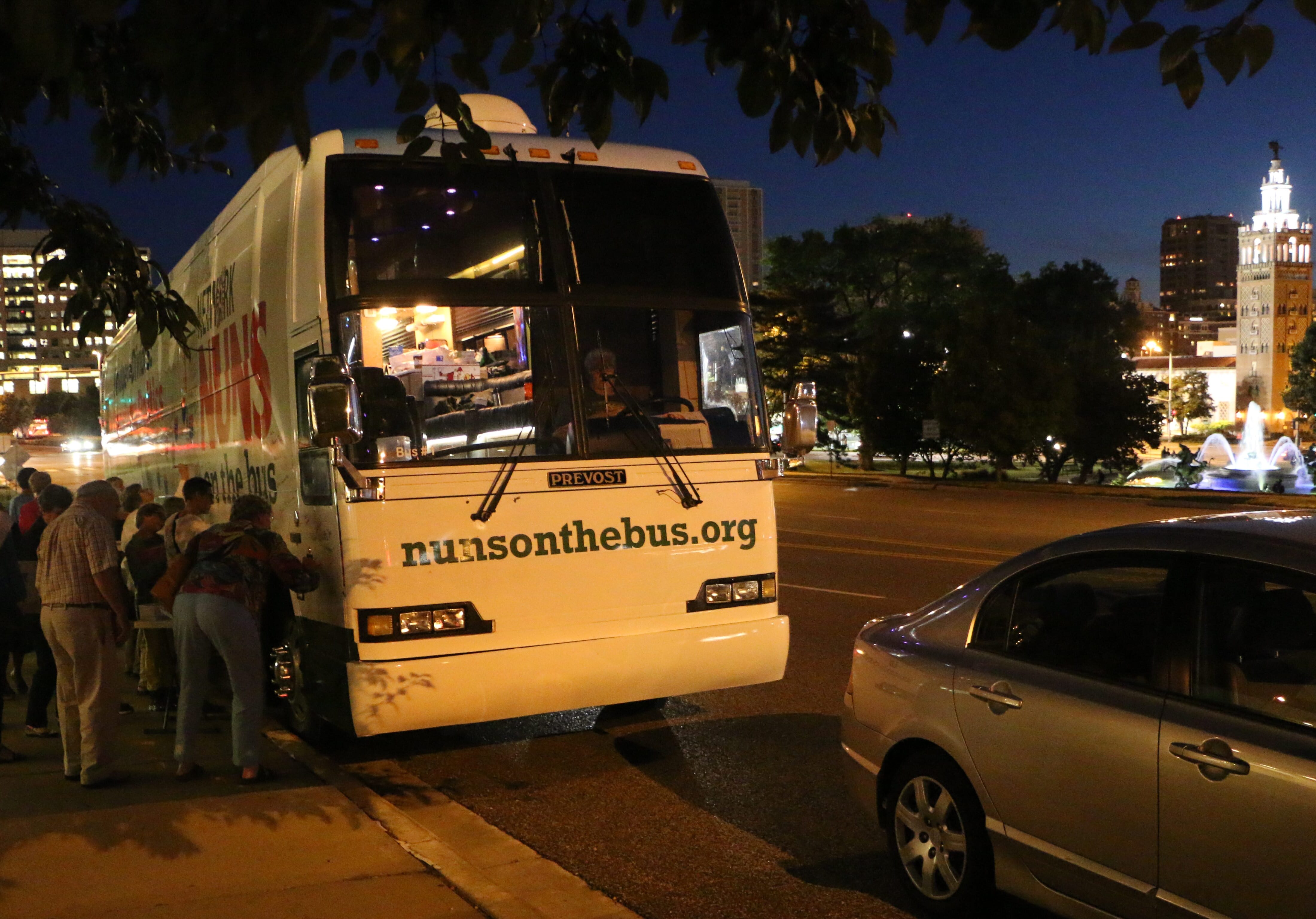 people signing tour bus