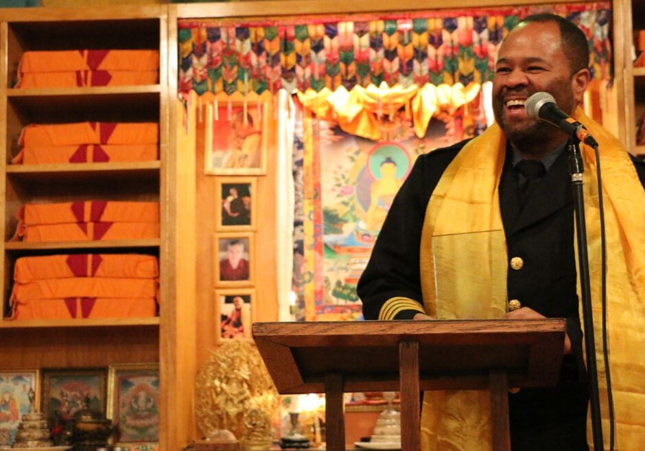 Police Chief Darryl Forte stands at a podium holding a glass award.