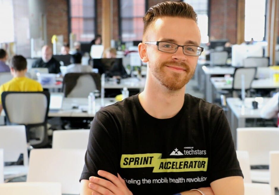 John Coler of Techstars poses in a room full of startups in the Sprint Accelerator. Photo by Kyle Geary