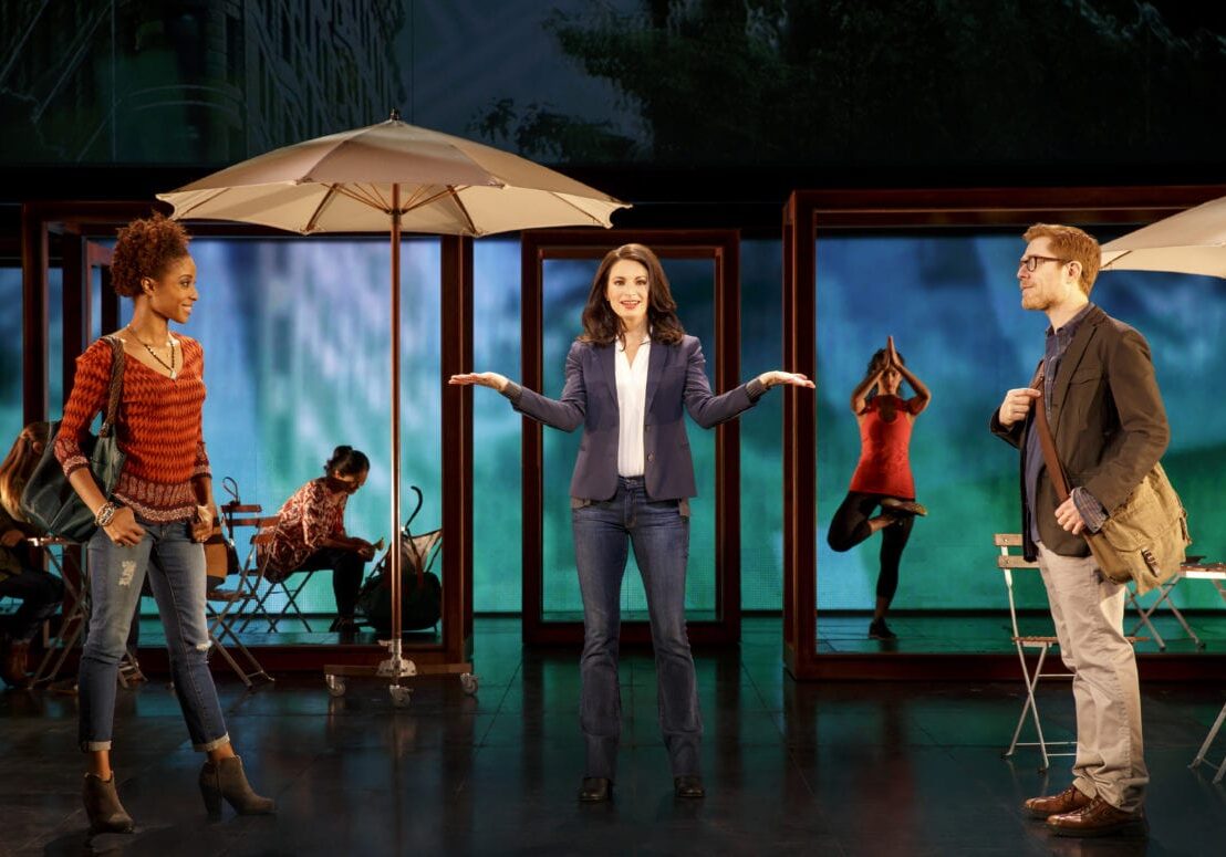 A woman stands on a stage.