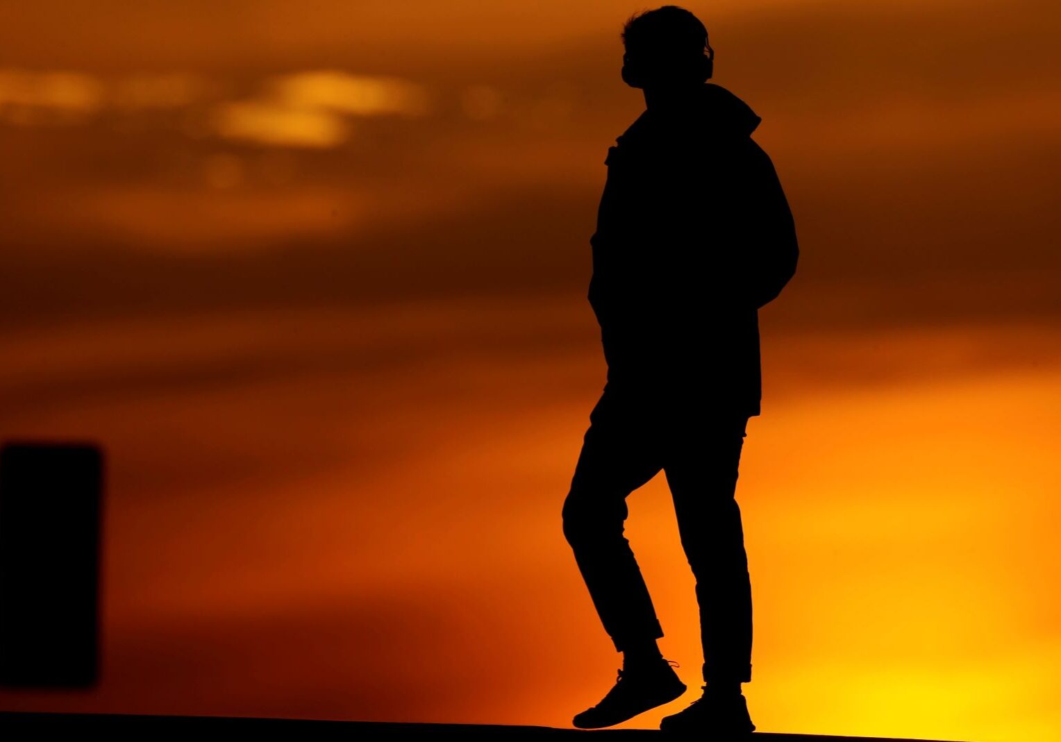 A person crosses a downtown street in Kansas City.