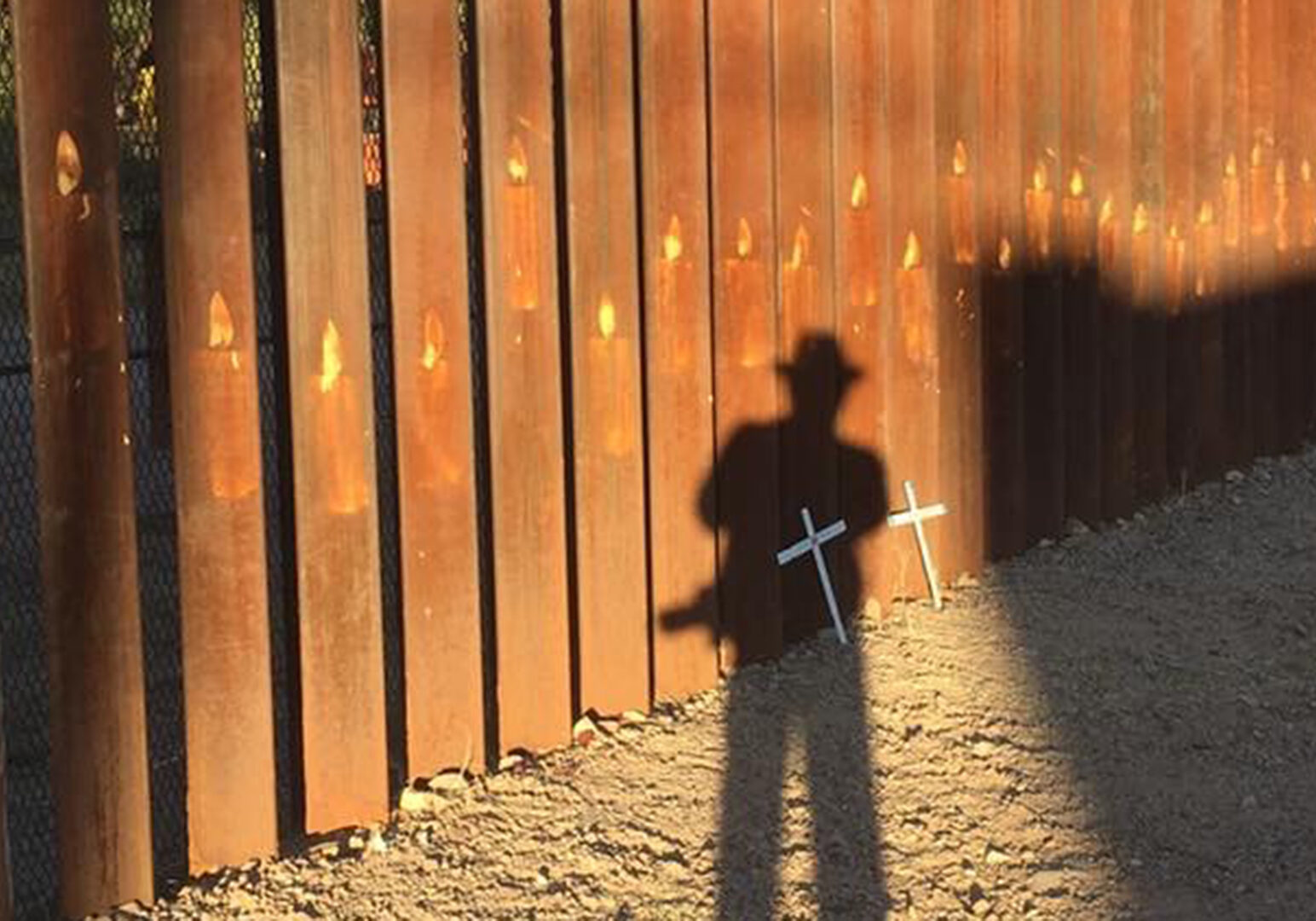 Israel Garcia Garcia's shadow is cast as he snaps a photo of a memorial site at the Border Fence. (Contributed | Israel Garcia Garcia)