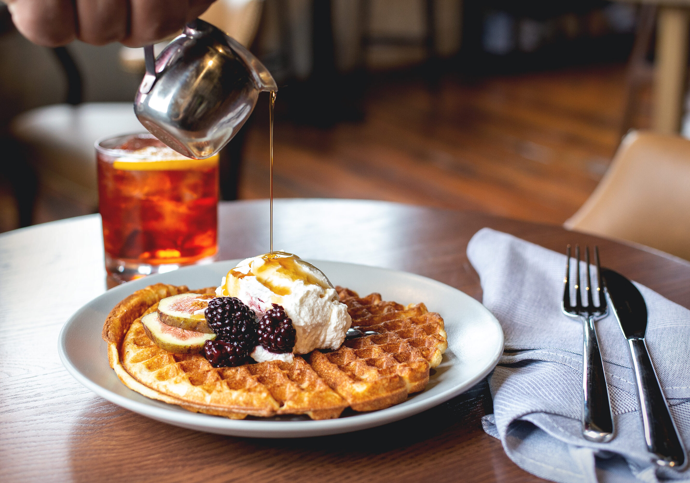 Whiskey syrup is poured over waffles.