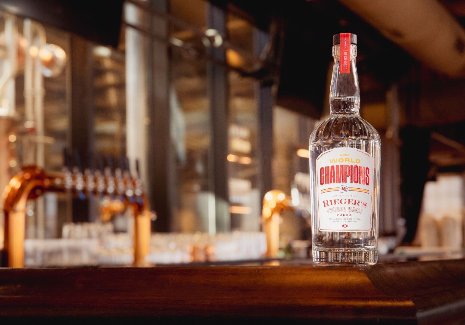 A bottle of J. Rieger & Co.'s special edition wheat vodka honoring the Chiefs sitting on a bar.