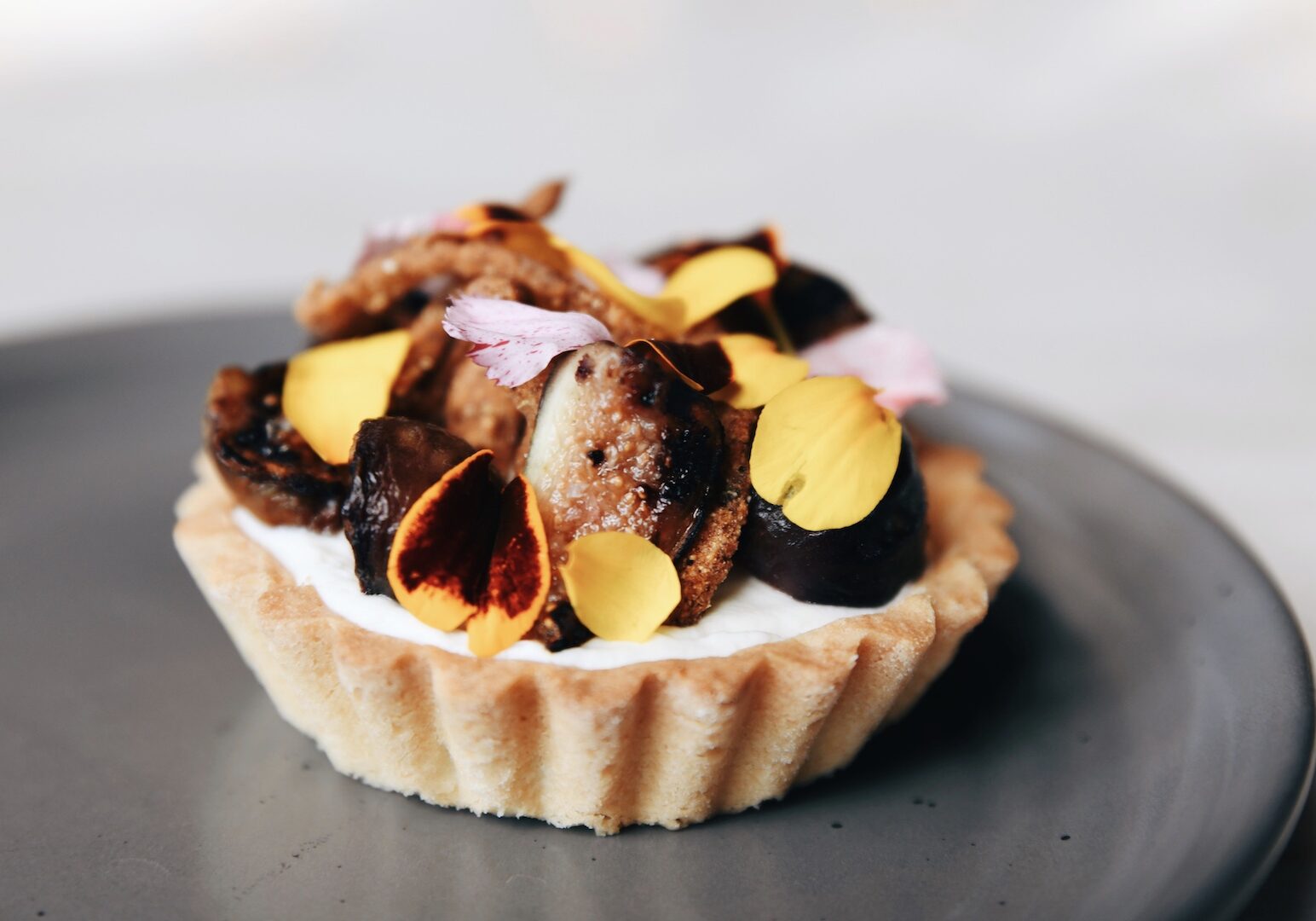 A caramelized onion tart sits on a platter.