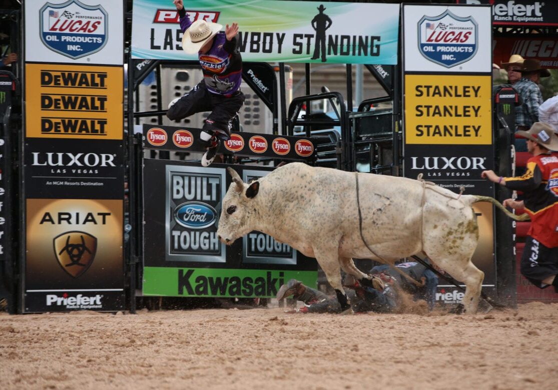 A man being thrown off a bull.