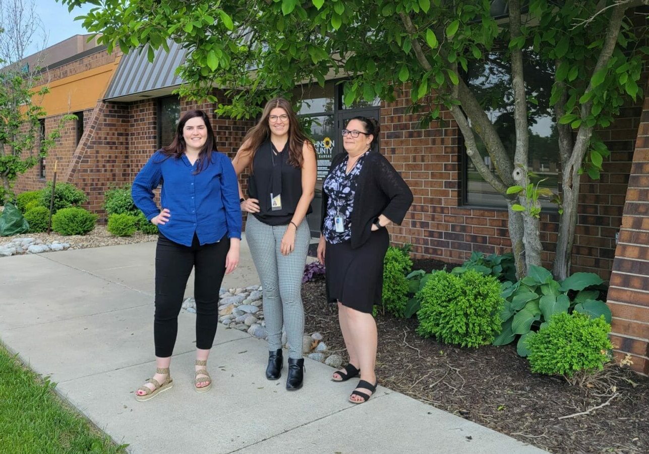 Heather McNeive, Jessa Molina and Teresa Spaeth standing in front of a brick building.