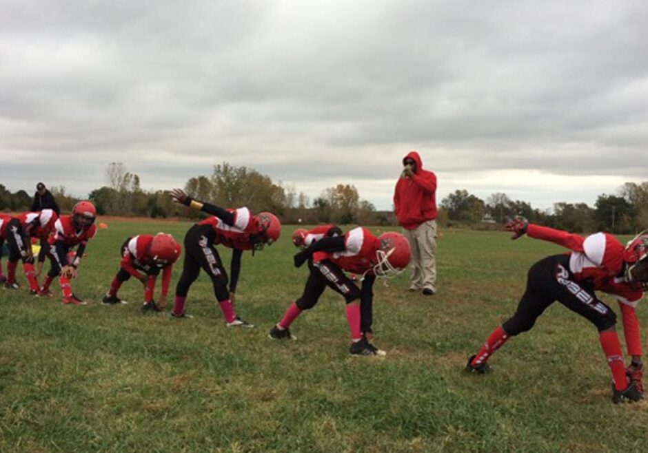 The KC United league plays weekly games in an empty field next to a church in western Kansas City, Kansas. (Photo: Alex Smith | Heartland Health Monitor)