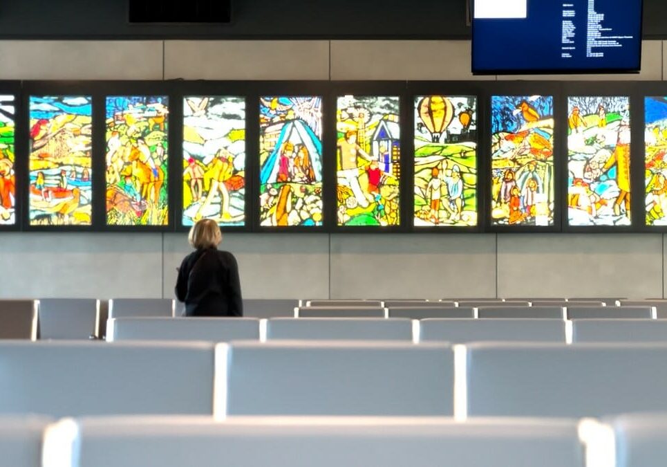 A traveler viewing panels of art at the new Kansas City International Airport.