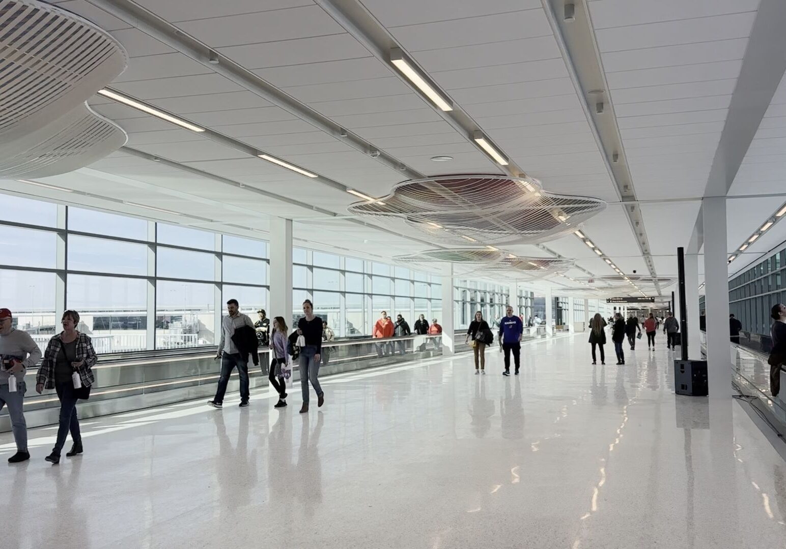 People use the moving sidewalks at the new Kansas City International Airport terminal.