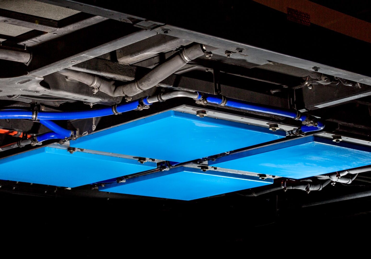 A blue plate bolted to the underside of EV buses at Kansas City International Airport will help push sustainability at the airport -- and potentially across the area.