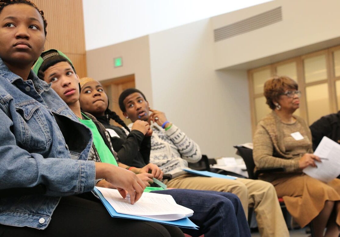 Students watch facilitator at mental health forum