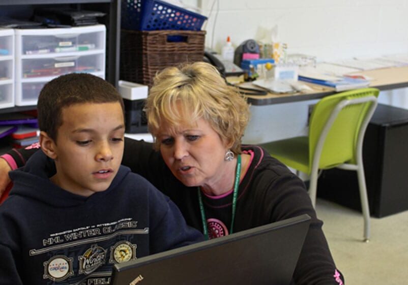 Teacher working with student in Topeka