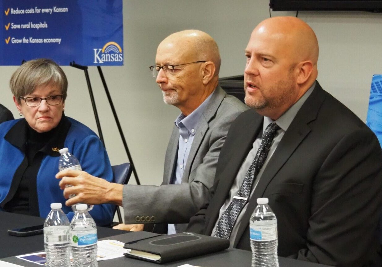 Gov. Laura Kelly, left, listens to a discussion about the advantage of expanding eligibility for Medicaid to lower-income Kansans as 40 states have done since 2014, including Missouri, Nebraska, Colorado and Oklahoma.