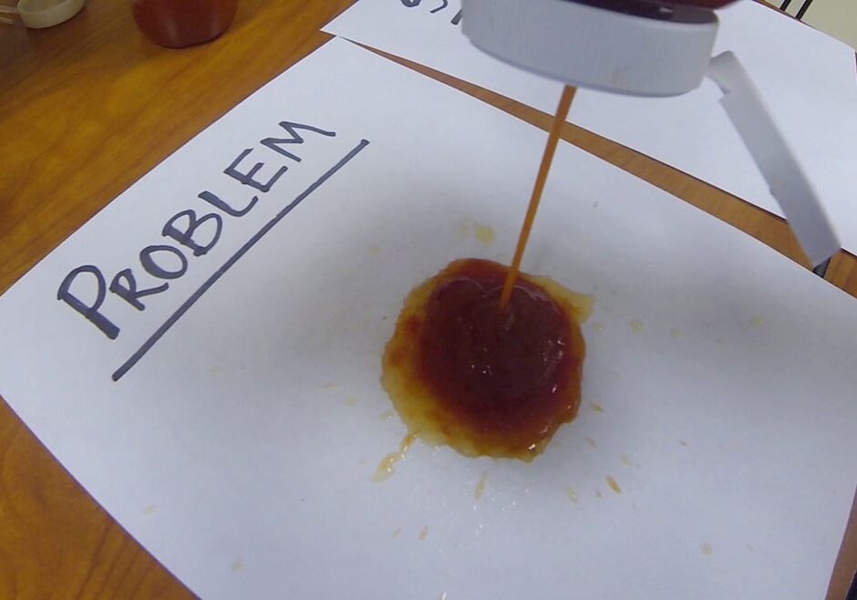 Photo of ketchup bottle squirting.