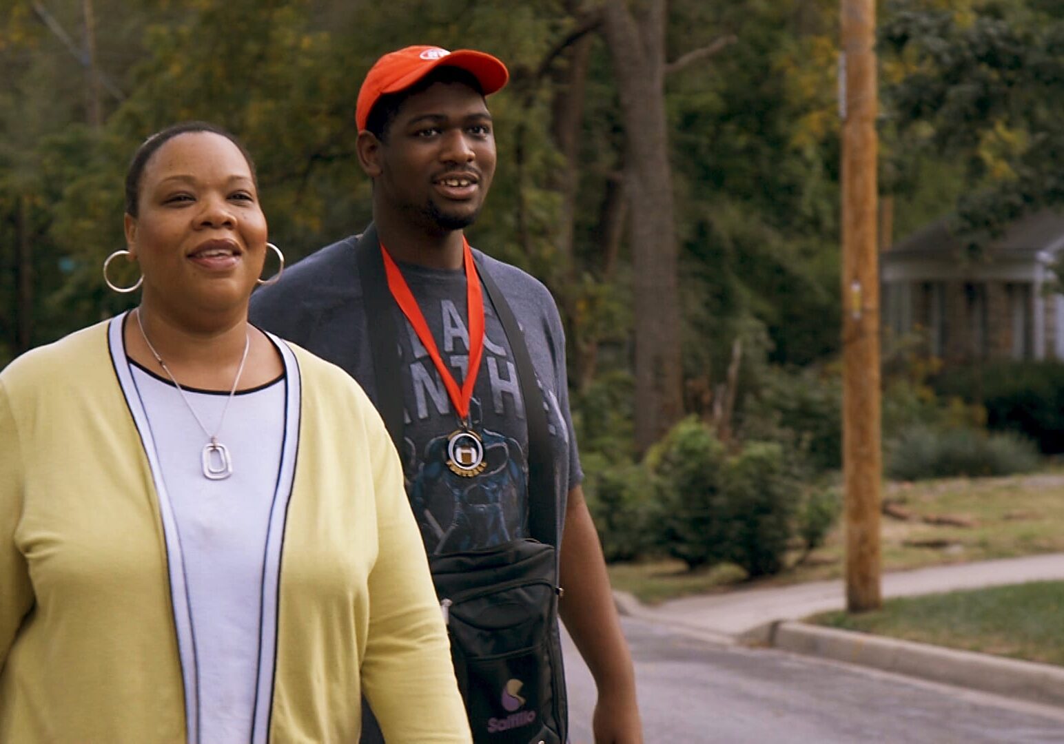Kim Riley (left) and her son Kendall take a walk around their neighborhood.