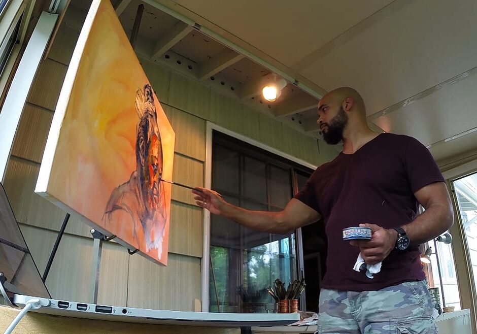 Kwanza Humphrey works on a new painting.